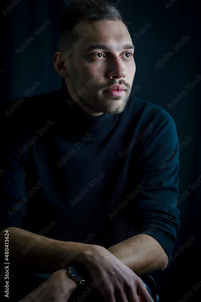 portrait of a young man who, with his gaze elsewhere, seems lost in his thoughts