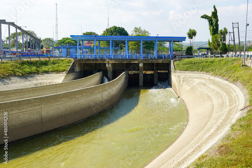 The water flow channel from the dam which is flowing with very heavy water when the dam door is opened. During the dry season, this water from the dam is used to irrigate vast agricultural land. © Faris Fitrianto