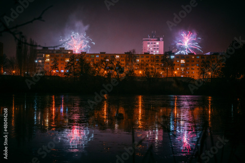new years eve celebration with fireworks over city with reflections © jedla