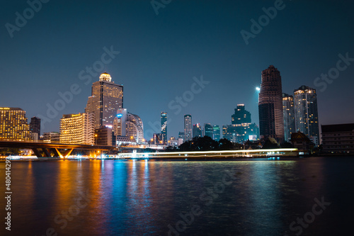 Canvas Print Night view of the Chao Phraya River with King Taksin the Great Sathon Bridge, State Tower, Sathorn Unique Tower and King Power Mahanakhon skyscrapers in Bangkok, Thailand