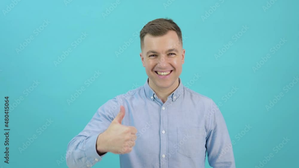 A man in a blue shirt raises his head and shows a sign of consent with his thumb up. Unbelievable promo A man in a blue shirt raises his head and shows a sign of consent with his thumb up. Unbelievable promo