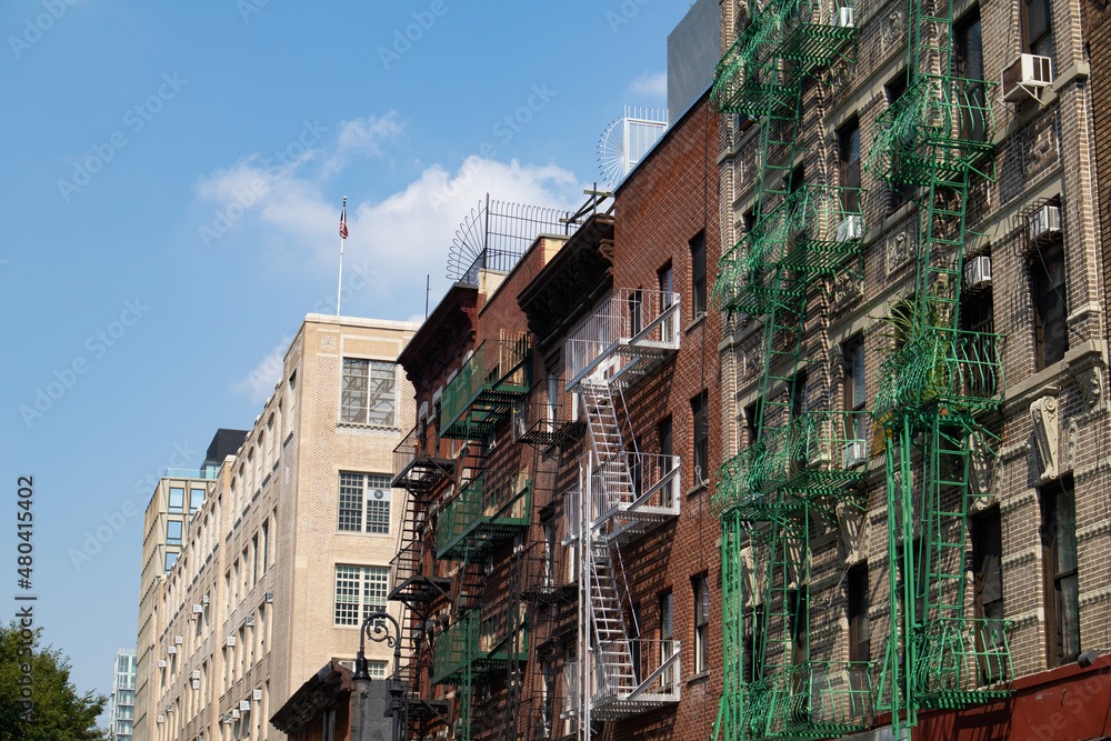 Row of Old Brick Apartment Buildings on the Lower East Side in New York City with Fire Escapes