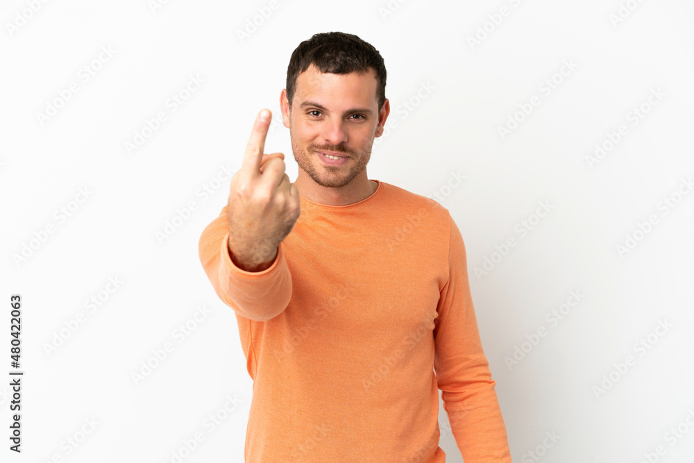 Brazilian man over isolated white background doing coming gesture Brazilian man over isolated white background doing coming gesture