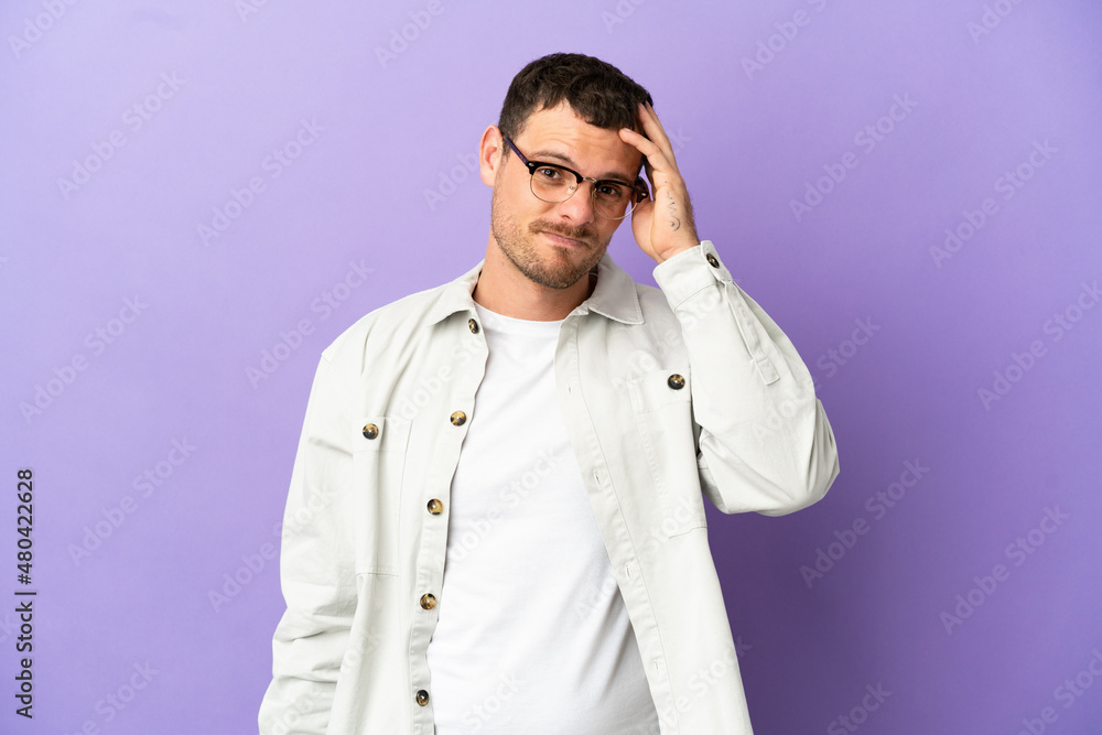 Brazilian man over isolated purple background with an expression of frustration and not understanding Brazilian man over isolated purple background with an expression of frustration and not understanding