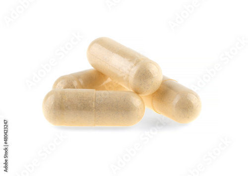 vitamins in medical capsules isolated on white background