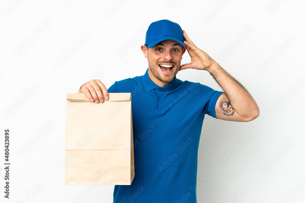 Brazilian taking a bag of takeaway food isolated on white background with surprise expression Brazilian taking a bag of takeaway food isolated on white background with surprise expression