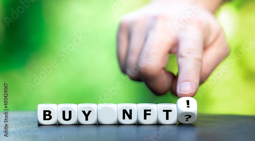 Symbol for buying non fungible token NFT. Hand turns dice and changes the expression "buy NFT?" to "buy NFT!".