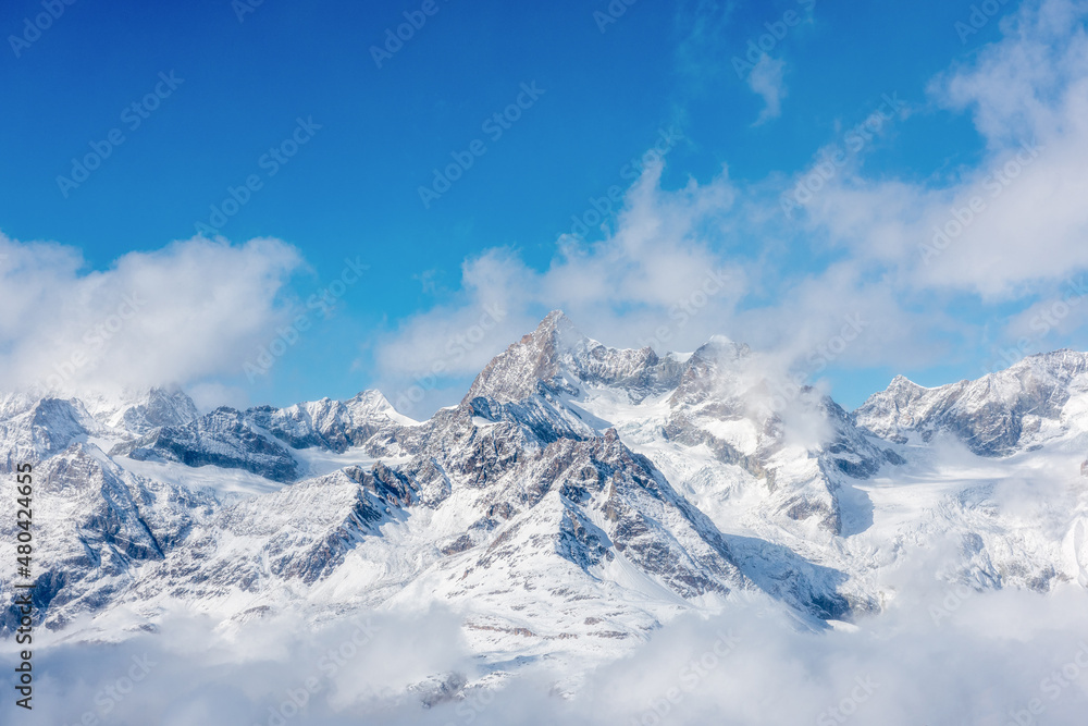 Snow-capped mountains against the blue sky