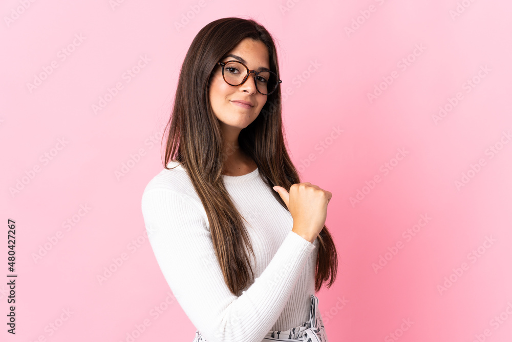 Young brazilian woman isolated on pink background proud and self-satisfied Young brazilian woman isolated on pink background proud and self-satisfied