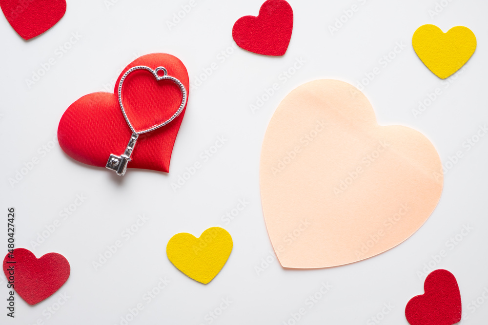 A candle, hearts, a heart-shaped key and a sticker for the inscription for Valentine's day A candle, hearts, a heart-shaped key and a sticker for the inscription for Valentine's day