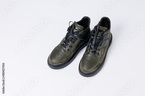Leather short men's boots on a white background. Winter boots collection 2022.