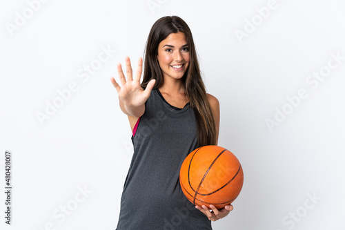 Young brazilian woman playing basketball isolated on white background counting five with fingers © luismolinero