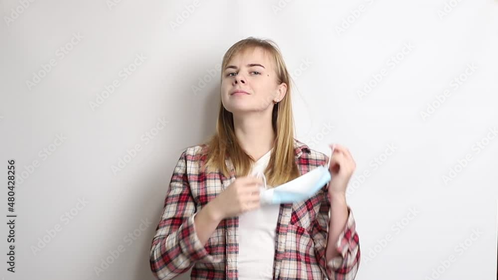 girl takes off her medical mask and takes a deep breath girl takes off her medical mask and takes a deep breath
