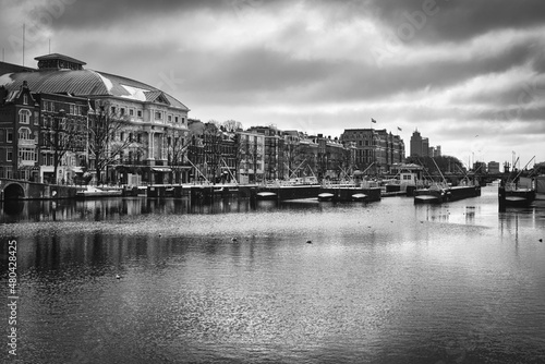 View over the Amstel river in the historic city center of Amsterdam in classic Black and White