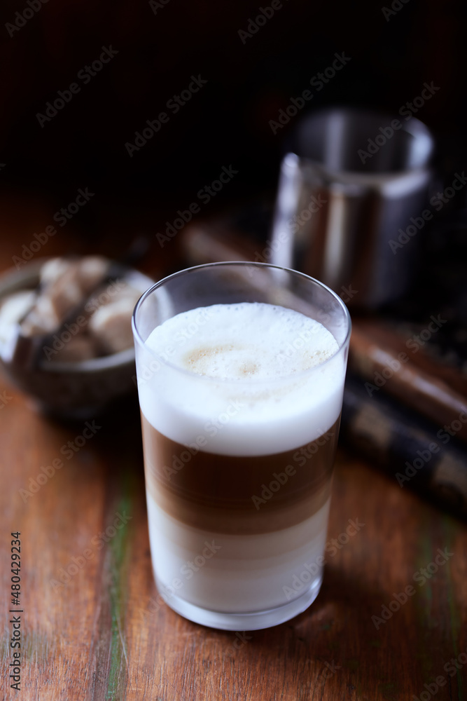 Coffee with milk on wooden background. Soft focus. Close up. Coffee with milk on wooden background. Soft focus. Close up.