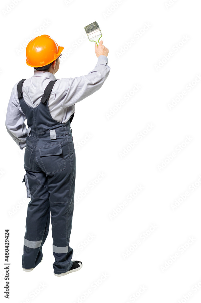 an elderly woman, a worker in special clothes, works with a brush. Woman, grandmother stands with her back to us. isolated an elderly woman, a worker in special clothes, works with a brush. Woman, grandmother stands with her back to us. isolated