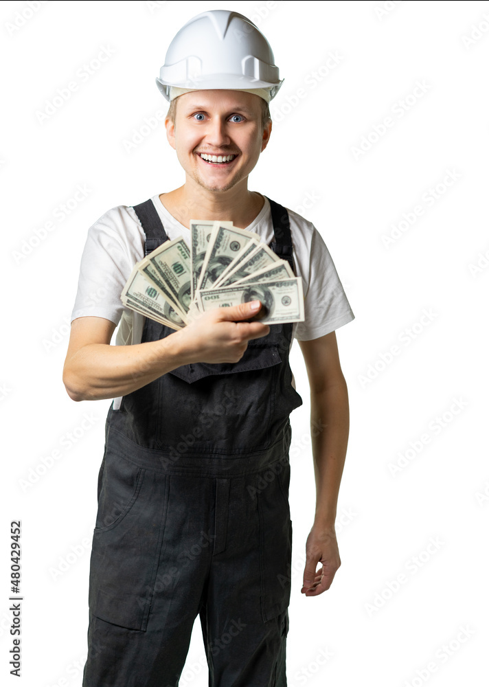 specialist, young worker, engineer insanely happy about the amount of money. a man in special clothes holds a fan of dollars and looks at him joyfully. isolated specialist, young worker, engineer insanely happy about the amount of money. a man in special clothes holds a fan of dollars and looks at him joyfully. isolated