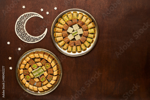 Ramadan traditional sweets baklava. Middle Eastern , turkish dessert . Ramadan background with moon and stars . Top view with copy space