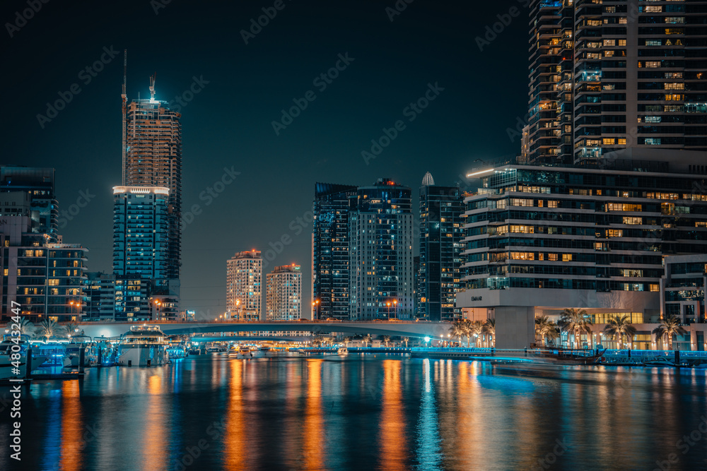 Fantastic nighttime skyline with illuminated skyscrapers. Dubai, UAE