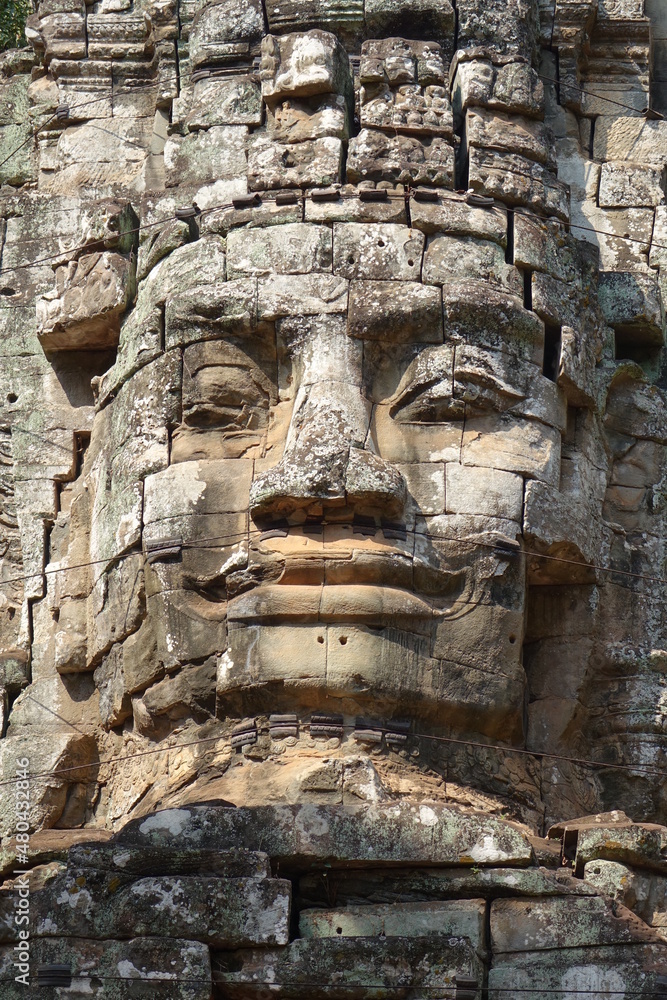 Massive stone relief on top of Victory Gate of impressive Khmer ruin city Angkor Thom (vertical image), Siem Reap, Cambodia Massive stone relief on top of Victory Gate of impressive Khmer ruin city Angkor Thom (vertical image), Siem Reap, Cambodia