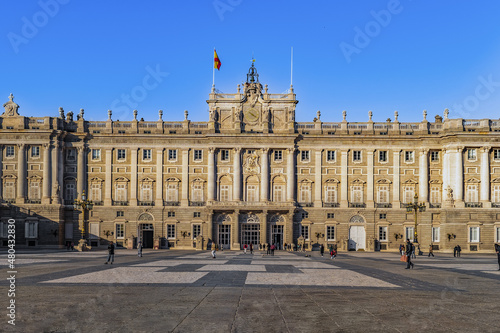 Madrid, Spain - November 30, 2021: Front view of the Royal Palace of Madrid. View from the Plaza de la Armeria on the main facade of the Spanish castle