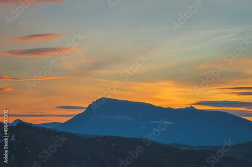 A picturesque landscape view of the French Alps mountains in the Hautes-Alpes department during the sunset