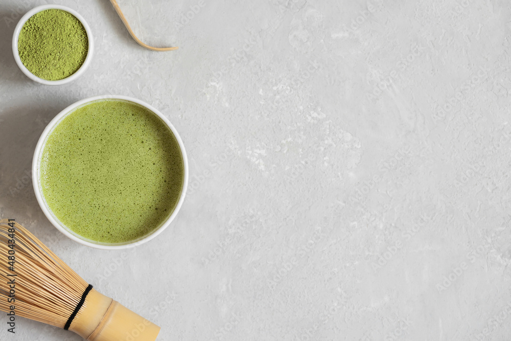 Matcha tea on a gray background. Traditional Japanese green tea. Organic healthy herbal drink. Copy space, top view, flat lay. Matcha tea on a gray background. Traditional Japanese green tea. Organic healthy herbal drink. Copy space, top view, flat lay.