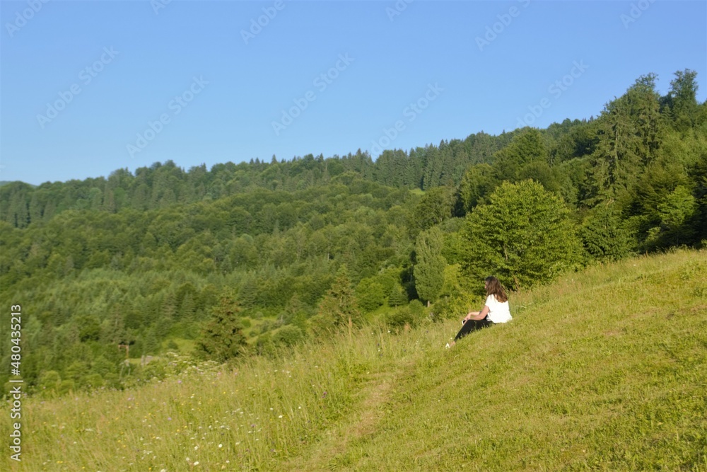 girl on the slope in the grass