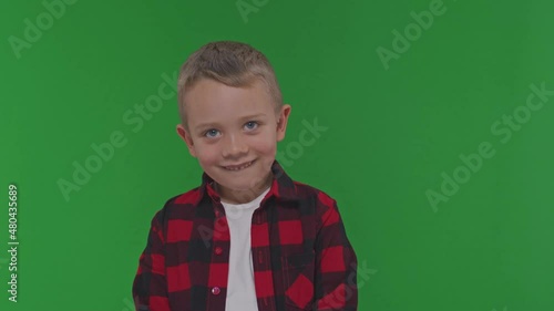 Close up shot of cute little boy shakes his head in agreement 