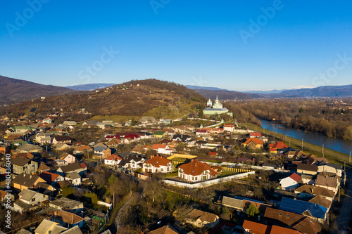 The Mukachevo city at the evening with beautiful mountains panorama aerial view