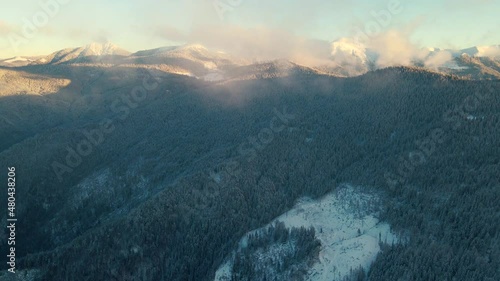 Relaxing flight above the misty mountains cold. Winter aerial footage