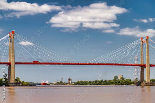 Zarate suspension bridge (Argentina) with cargo ships in the background photo