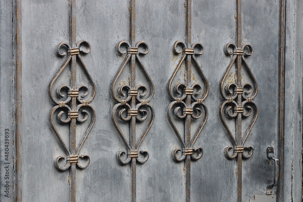 gray brown metal texture of iron wall and twigs in a forged old pattern gray brown metal texture of iron wall and twigs in a forged old pattern