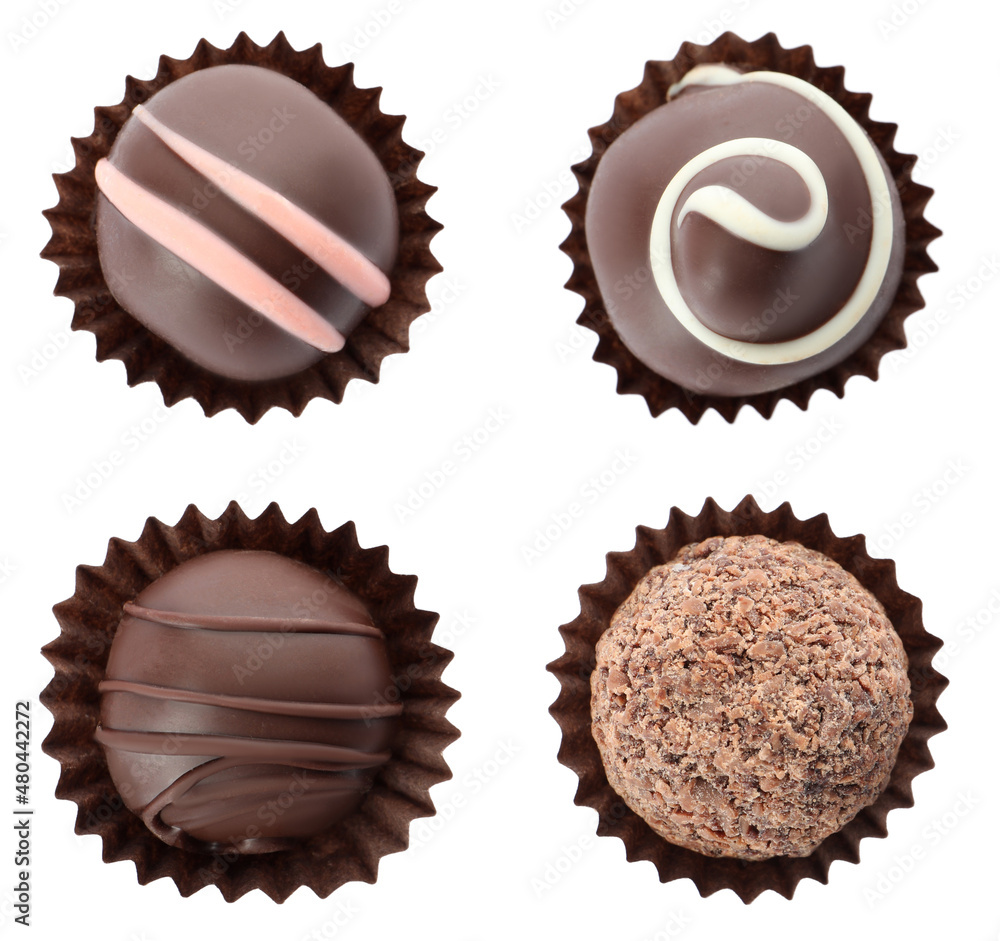 Set with delicious sweet chocolate truffles on white background, top view Set with delicious sweet chocolate truffles on white background, top view