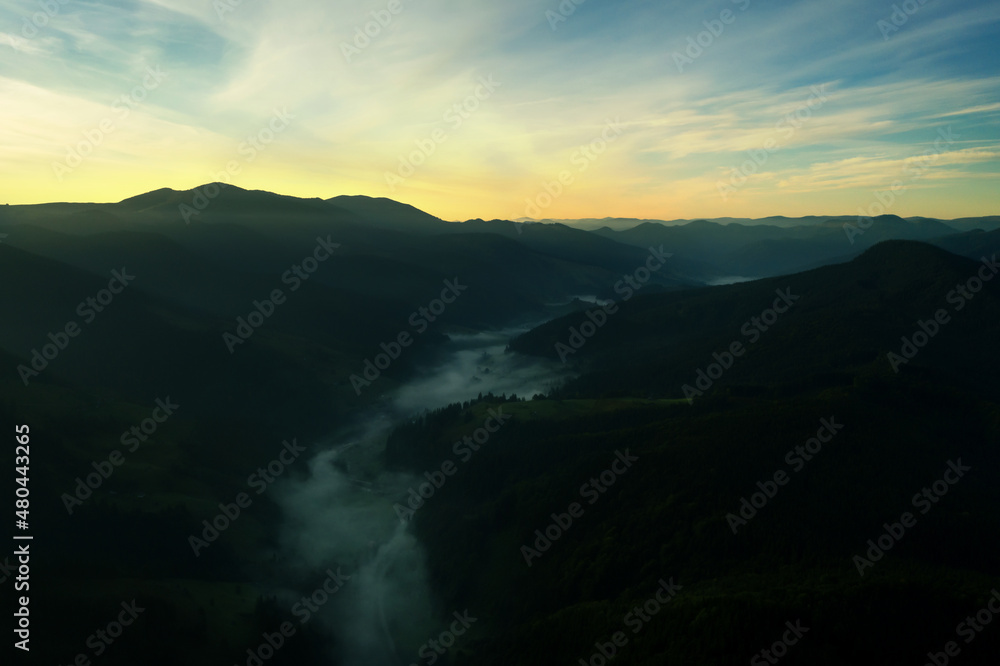 Picturesque view of foggy mountains and beautiful sky in early morning. Drone photography