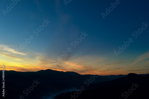 Silhouette of mountain landscape at sunset . Drone photography