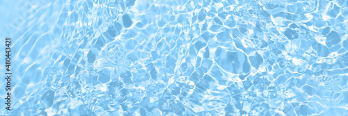 Fresh water background. Bright blue pattern with natural rippled water texture and bubbles. Top view web banner. Clear water surface background.