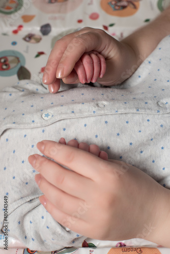 baby's hands newborn in mom's palms mom's love