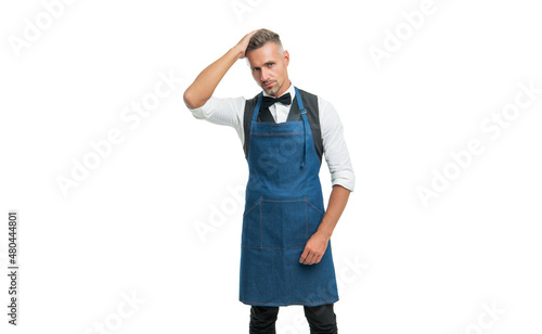Photography Serious man in bow and bartender apron fixing hair isolated on white, barkeeper