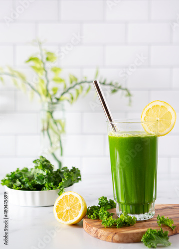 Healthy and refreshing homemade green vegetable juice made from kale and lemon; copy space