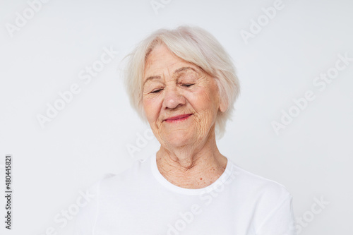 close-up of a cheerful elderly woman in a white t-shirt
