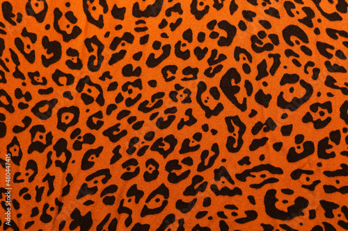 Cotton fabric with leopard print. Orange with black spots. Material for the dress.