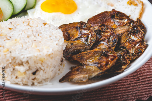 Danggitsilog- is a famous Pinoy breakfast combination of fried Danggit (dried fish), egg, and garlic rice. photo