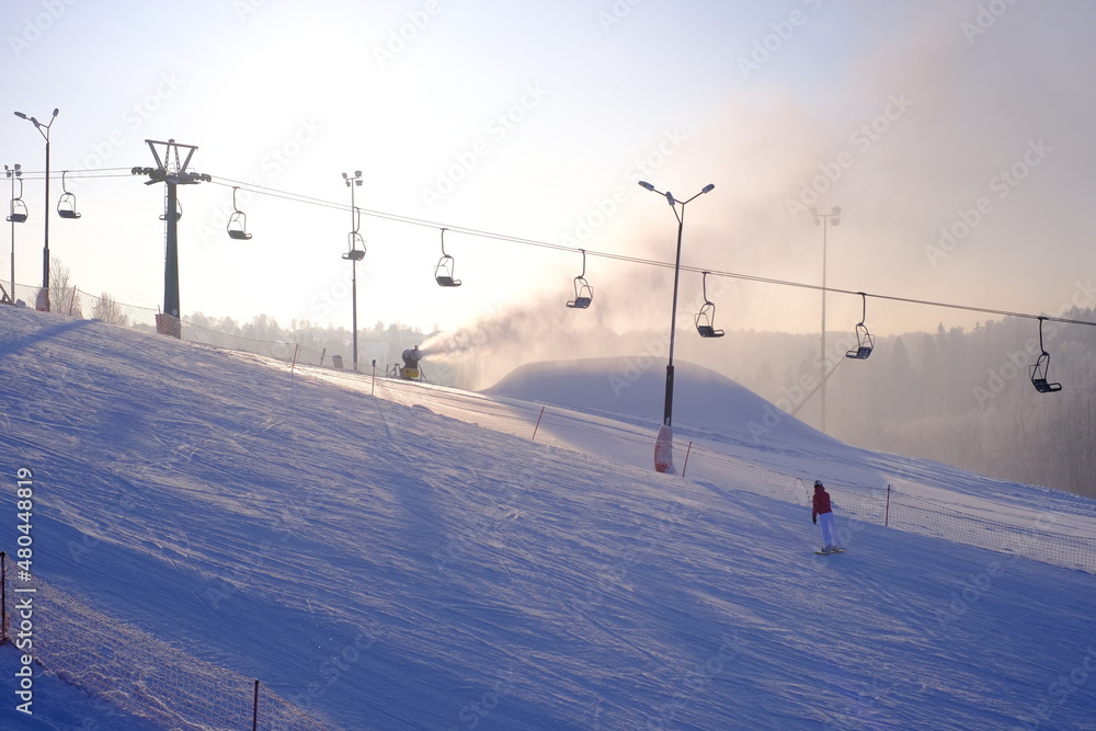 Snow-covered trees in hoarfrost at a ski resort, snow cannon, ski lift, funicular,

