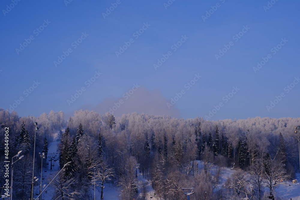Snow-covered trees in hoarfrost at a ski resort, lift, funicular, ski lift Snow-covered trees in hoarfrost at a ski resort, lift, funicular, ski lift