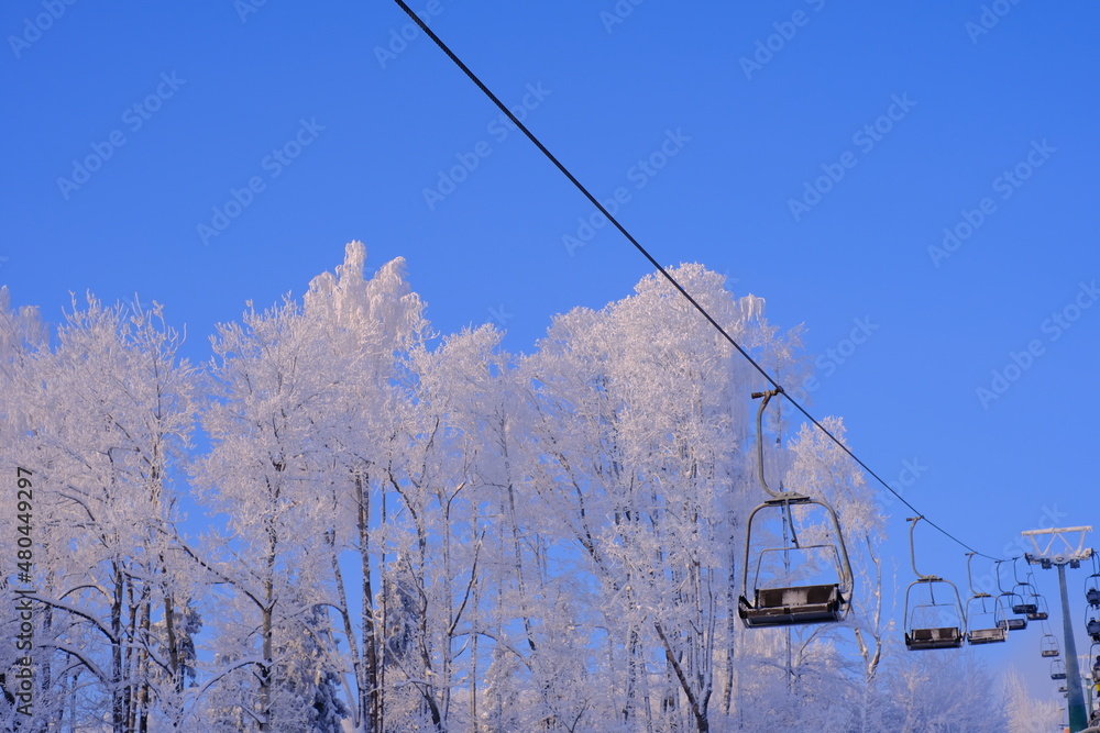 Snow-covered trees in hoarfrost at a ski resort, lift, funicular, ski lift