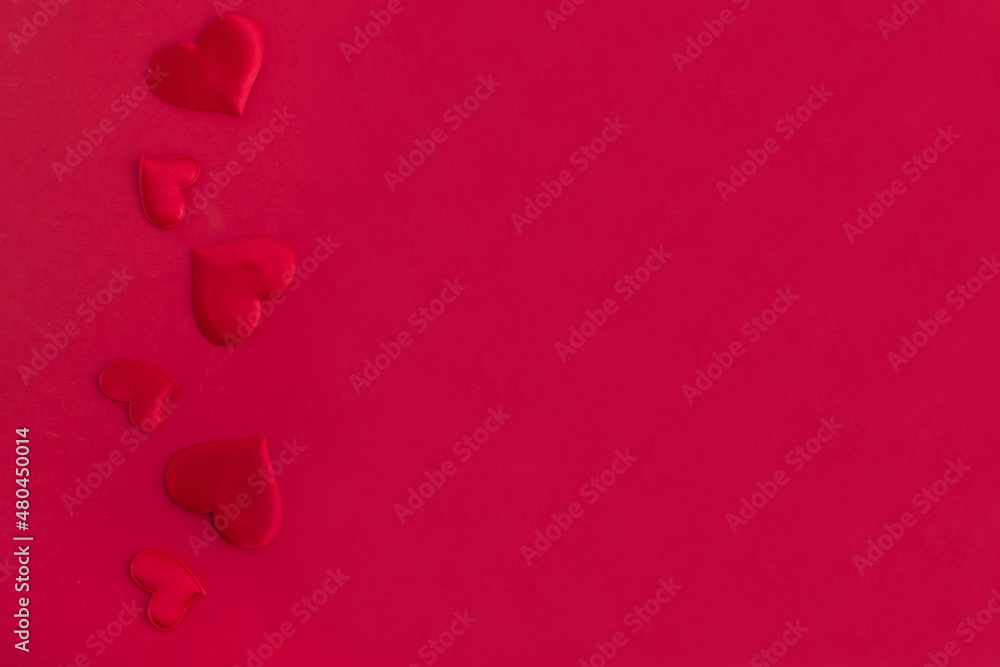 Red hearts on a red background, place for text. Ð¡ongratulations on Valentine's Day, mother's day, birthday