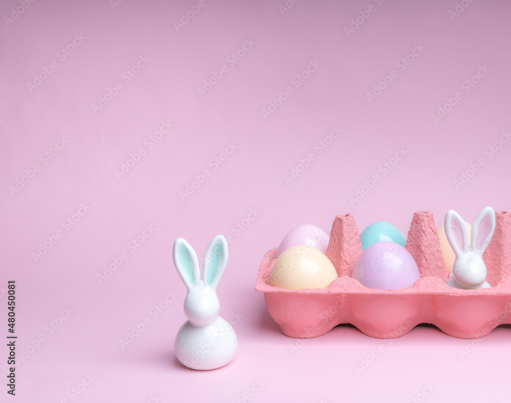 Shot of arrangement decoration Happy Easter holiday on a pink background.Colorful Easter eggs in paper box. Copy space. Shot of arrangement decoration Happy Easter holiday on a pink background.Colorful Easter eggs in paper box. Copy space.