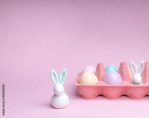 Shot of arrangement decoration Happy Easter holiday on a pink background.Colorful Easter eggs in paper box. Copy space. photo