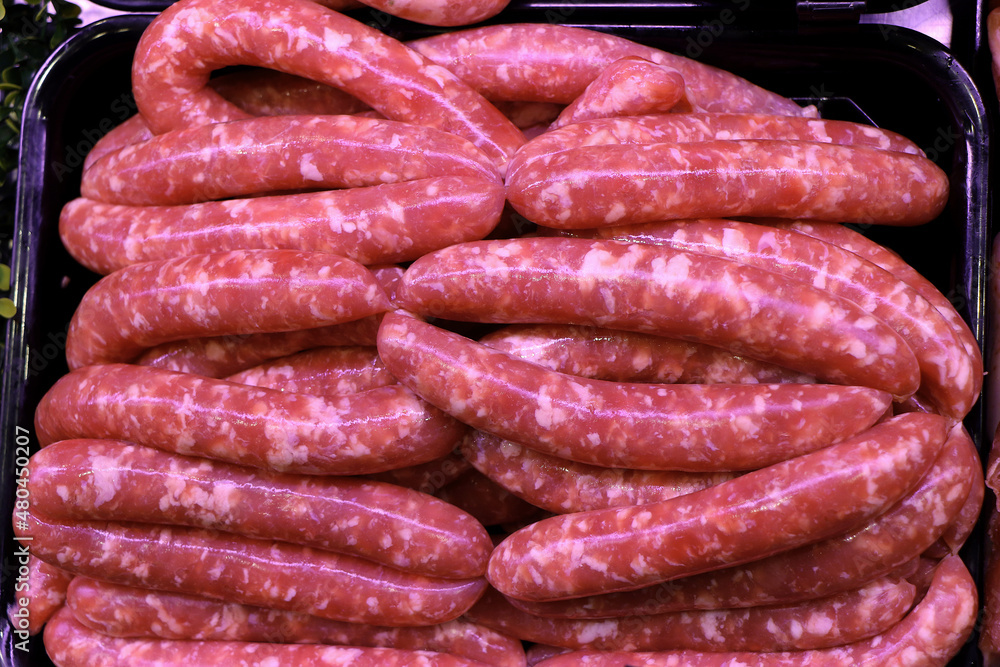 Raw Italian sausage ready to be cooked. Meat for sale in the butcher's shop Raw Italian sausage ready to be cooked. Meat for sale in the butcher's shop